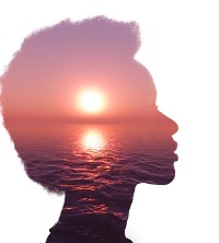 An image of a woman's head picturing a serine sunset over the water to calm down, part of what she learned from Counselors for Peoria IL