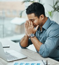A man on his computer, dealing with Stress Management in Peoria IL