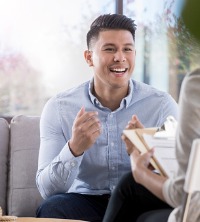 A happy man talking with counselor after successful Stress Management Therapy in Peoria IL